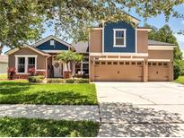 Charming two-story home with a three car garage, well-maintained landscaping, and a welcoming front entrance at 3380 Pawleys N Loop, St Cloud, FL 34769