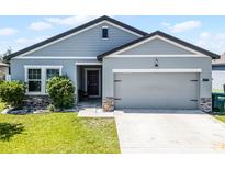 Charming single-Gathering home with well-manicured lawn and an attached two-car garage at 3519 Fernanda Dr, Deltona, FL 32738