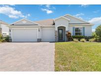 Beautiful single-story home with a three-car garage and manicured front lawn at 4119 Sunset Preserve Blvd, Orlando, FL 32820