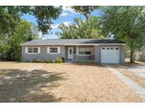 Charming single-story home featuring a well-maintained yard and attached garage at 439 Sunrise Ct, Orlando, FL 32803
