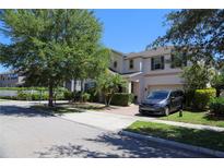 Beautiful two-story home with landscaped front yard, attached garage, and inviting curb appeal at 9005 Reflection Pointe Dr, Windermere, FL 34786