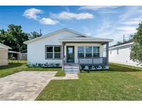Charming one-story home with a welcoming front porch and well-manicured lawn at 1040 20Th St, Orlando, FL 32805