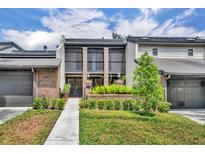 Inviting townhome with a brick facade, small front yard, and an accessible walkway leading to the front door at 1130 Washington Ave # 11, Winter Park, FL 32789