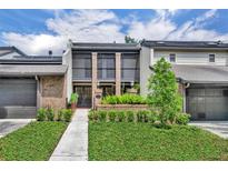 Charming townhome featuring brick accents, double balconies, and a beautifully landscaped front yard at 1130 Washington Ave # 11-C, Winter Park, FL 32789