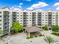 Luxury condo building featuring a porte-cochere entrance and multiple levels of balconies at 14501 Grove Resort Ave # 2438, Winter Garden, FL 34787