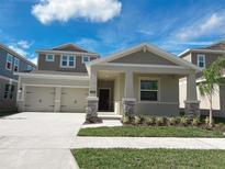 Charming two-story home with a manicured lawn, a two-car garage and stone accents at 16436 Parable Way, Winter Garden, FL 34787