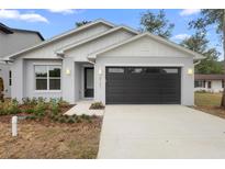 Charming single-story home featuring a modern exterior, neat landscaping, and an attached two-car garage at 2131 Brighton Ln, Orlando, FL 32817
