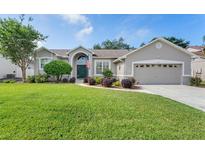 Charming home featuring a well-manicured lawn, tidy landscaping, and a two-car garage at 249 Mill Slough Rd, Oviedo, FL 32766