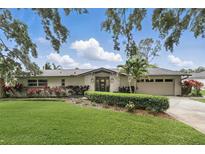 Charming single-story home featuring a landscaped lawn, brick accents, and a well-maintained yard at 2756 Summerfield Rd, Winter Park, FL 32792