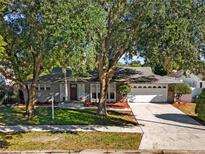 Charming home featuring mature trees, well-kept landscaping, and a two-car garage at 2859 T C U Blvd, Orlando, FL 32817