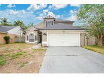 Two-story home featuring neutral paint, a two-car garage, arched windows, and a well-maintained roof in a suburban setting at 468 Wexdon Ct, Lake Mary, FL 32746
