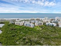 Stunning aerial view of condos near a scenic beach and blue ocean waters at 5300 S Atlantic Ave # 5507, New Smyrna Beach, FL 32169