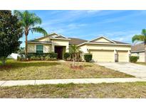 Well-maintained single Gathering home with manicured landscaping and a three car garage at 1062 Rock Creek St, Apopka, FL 32712