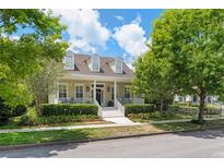 Charming two-story home with a cozy front porch, dormer windows, and a well-manicured landscaped yard at 1184 Fern Ave, Orlando, FL 32814