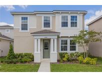 Charming two-story home featuring a covered front porch and well-maintained landscaping at 11944 Sunsail Ave, Orlando, FL 32832
