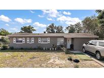 Charming single-story home featuring decorative shutters, neutral exterior, and well-lit front entrance, perfect for a welcoming ambiance at 2921 Bon Air Dr, Orlando, FL 32818