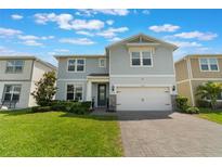 Charming two-story home with a well-manicured lawn and a two-car garage at 5226 Northern Flicker Dr, St Cloud, FL 34771