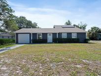 Charming single-story home featuring a well-maintained lawn, neutral exterior and attached garage at 601 Blackstone Ave, Deltona, FL 32725