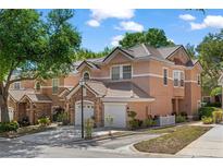 Charming townhome with attached garage, beautiful landscaping, and a well-maintained exterior in a lovely community at 7628 Bay Port Rd # 43, Orlando, FL 32819