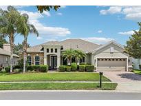 Charming single-story home with lush landscaping, stone accents, and a spacious three-car garage at 9843 Nokay Dr, Orlando, FL 32836