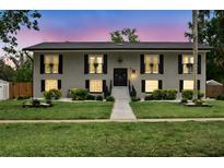 Charming two-story home with a manicured lawn and decorative shutters, exudes classic curb appeal at 103 Cherry Hill Cir, Longwood, FL 32779