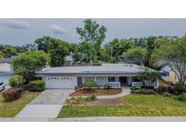 An aerial view showcases this well-maintained home with a lush front yard and attached garage at 2171 Chippewa Trl, Maitland, FL 32751