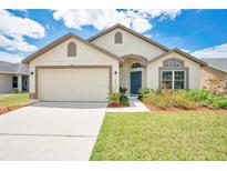 Charming single-story home with a well-manicured lawn, a two-car garage, and inviting curb appeal at 2541 Bobby Lee Ln, St Cloud, FL 34772