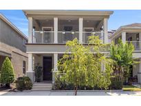 Charming two-story home features a double porch, neutral paint, and meticulously kept landscaping at 308 Michael Blake Blvd, Winter Springs, FL 32708