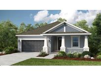 Charming single-story home featuring a two-car garage and a beautifully landscaped front yard at 4704 Coral Harbour Rd, Kissimmee, FL 34758