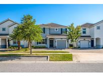 Charming two-story home boasts manicured lawn, attached garage, and welcoming entrance at 4807 Kings Castle Cir, Kissimmee, FL 34746