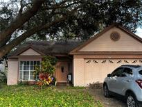Charming single-story home featuring a two-car garage and well-maintained front yard at 567 Queensbridge Dr, Lake Mary, FL 32746