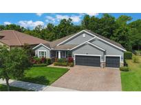 Charming single-Gathering home with a well-maintained lawn, mature landscaping, and a three-car garage at 595 American Holly Pl, Oviedo, FL 32765