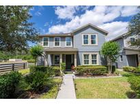Charming two-story home featuring manicured landscaping, a walkway, and a welcoming facade at 6543 Orange Cream Aly, Winter Garden, FL 34787