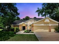 Charming two-story home with a well-maintained lawn, mature trees and a two car garage at 10664 Spring Buck Trl, Orlando, FL 32825