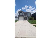 Charming two-story home with a well-manicured lawn and a spacious driveway at 1321 Carey Glen Cir, Orlando, FL 32824