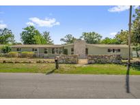 Charming single-story home with a stone accent wall and a well-maintained lawn at 1491 Granada Ave, Daytona Beach, FL 32117