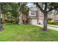 Charming townhome featuring a well-manicured lawn and two-car garage at 2110 Stockton Dr, Sanford, FL 32771