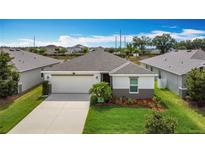 Charming one-story home with a two car garage, a well-manicured lawn, and tasteful landscaping at 3216 Casa Del Rey Ave, Kissimmee, FL 34746