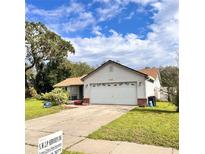 Charming single-Gathering home with attached two-car garage and well-maintained lawn at 4235 Shades Crest Ln, Sanford, FL 32773