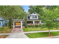 Charming home with an attached carport, lush landscaping, and eye-catching curb appeal at 641 E Livingston St, Orlando, FL 32803