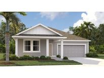 Charming single-story home boasts gray siding, complemented by well-manicured landscaping and a spacious two-car garage at 707 Junonia Blvd, New Smyrna Beach, FL 32168