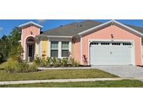 Charming single Gathering home with a two-car garage and beautifully landscaped front yard at 726 Coral Reef Way, Daytona Beach, FL 32124