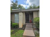 Inviting home entrance with a neatly landscaped yard and visible house number at 837 Pebble Creek Cir, Orlando, FL 32824