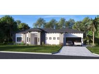 Beautiful single-story home with gray and white color scheme, manicured lawn, and a spacious two-car garage at 12818 Brunello Cir, Clermont, FL 34711