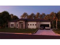 Stunning single-story home with modern elevation, manicured lawn, and a paver driveway leading to a two-car garage at 12818 Brunello Cir, Clermont, FL 34711