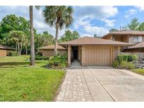 Charming home featuring mature landscaping and a brick walkway leading to the front door at 134 Heron Bay Cir, Lake Mary, FL 32746