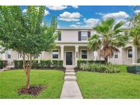 Charming home with lush landscaping, healthy lawn, and a welcoming walkway to the front door at 15060 Book Club Rd, Winter Garden, FL 34787