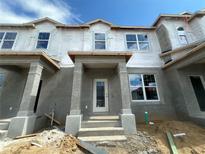 New construction townhome featuring a covered porch and modern architectural details at 15345 Burgtheater Dr, Winter Garden, FL 34787