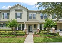 Charming two-story townhome with manicured landscaping and a welcoming front porch at 15477 Blackbead St, Winter Garden, FL 34787