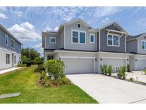 Charming two-story townhouse with a one-car garage and well-maintained landscaping at 1915 Terrapin Rd, Ocoee, FL 34761